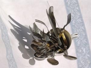 knives forks and spoons in cup of dry food dishes